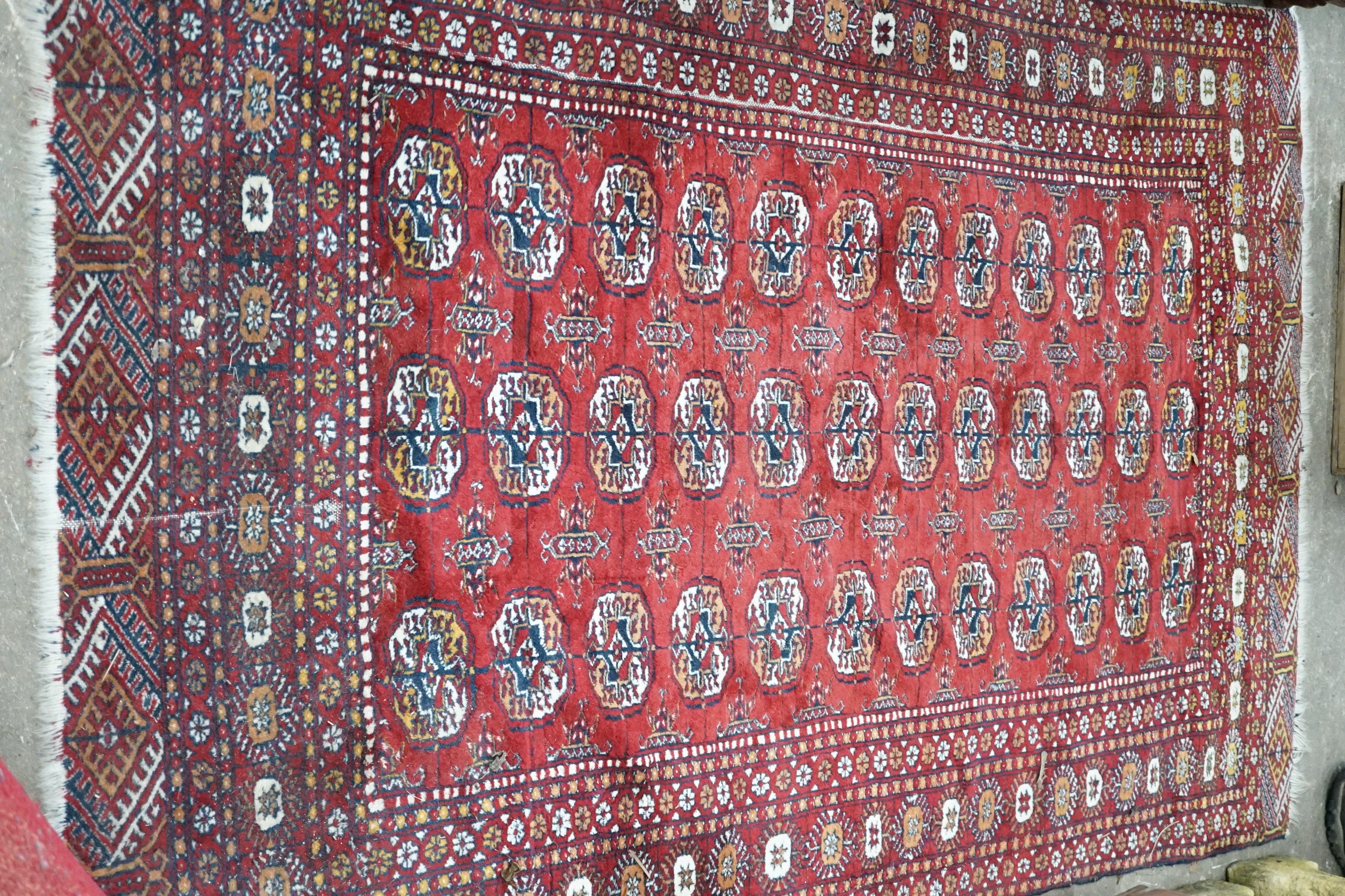 A Bokhara red ground rug, 186 x 122cm